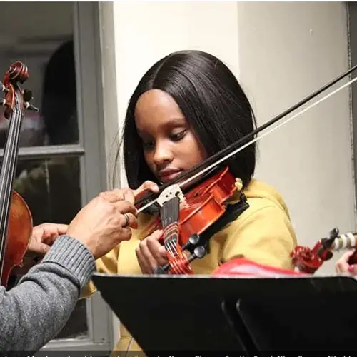 student learning how to play a violin